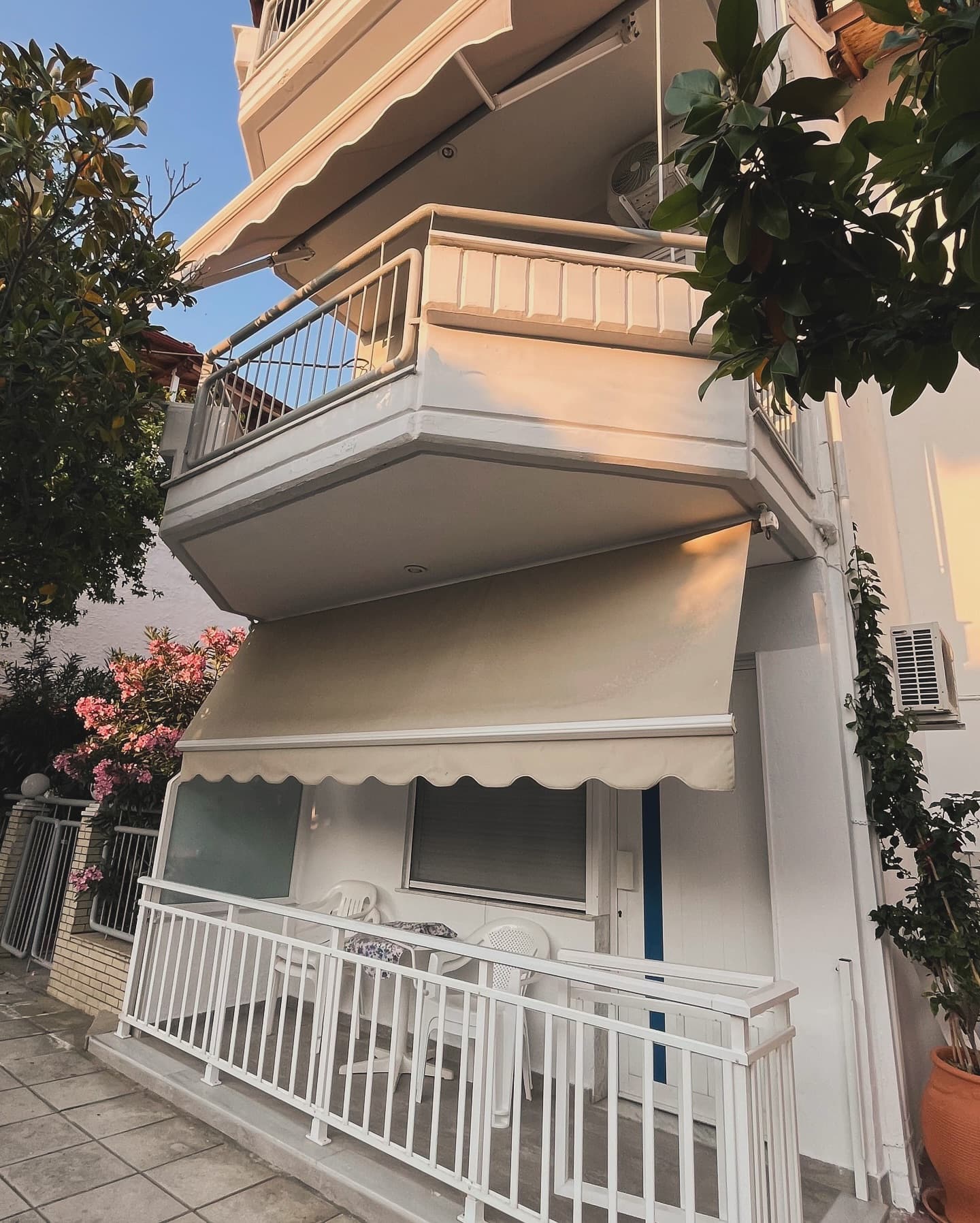 Apartment building exterior with balconies and bougainvillea