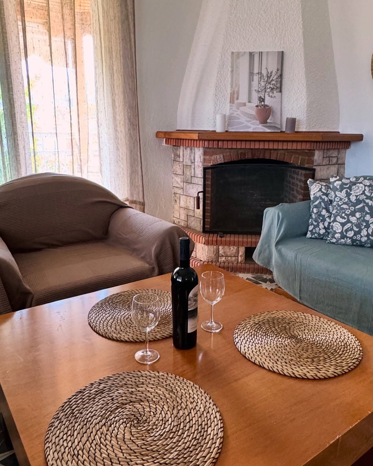 Living room with stone fireplace and dining table
